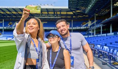 1 man and 2 women taking a selfie in the Everton stadium