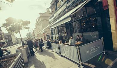Fly in the Loaf Exterior showing people outside in the sun