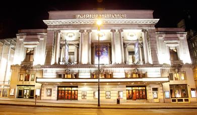 Front of the Liverpool Empire Theatre lit up with lights.