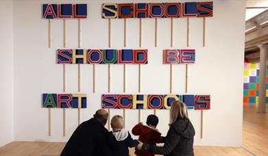 A sign that says ''All schools should be art schools''.