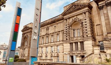 A sign saying MUSEUM with World Museum in the background.