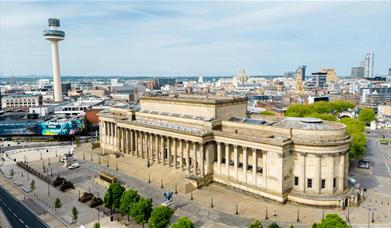 An exterior drone image of a huge ne-classical hall in Liverpool. Other buildings can be seen in the background