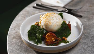 A plate of food sitting on a marble table top.